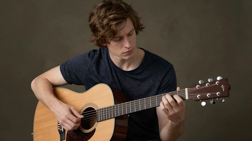 Creating a Structured Practice Schedule - Young Man Playing Guitar